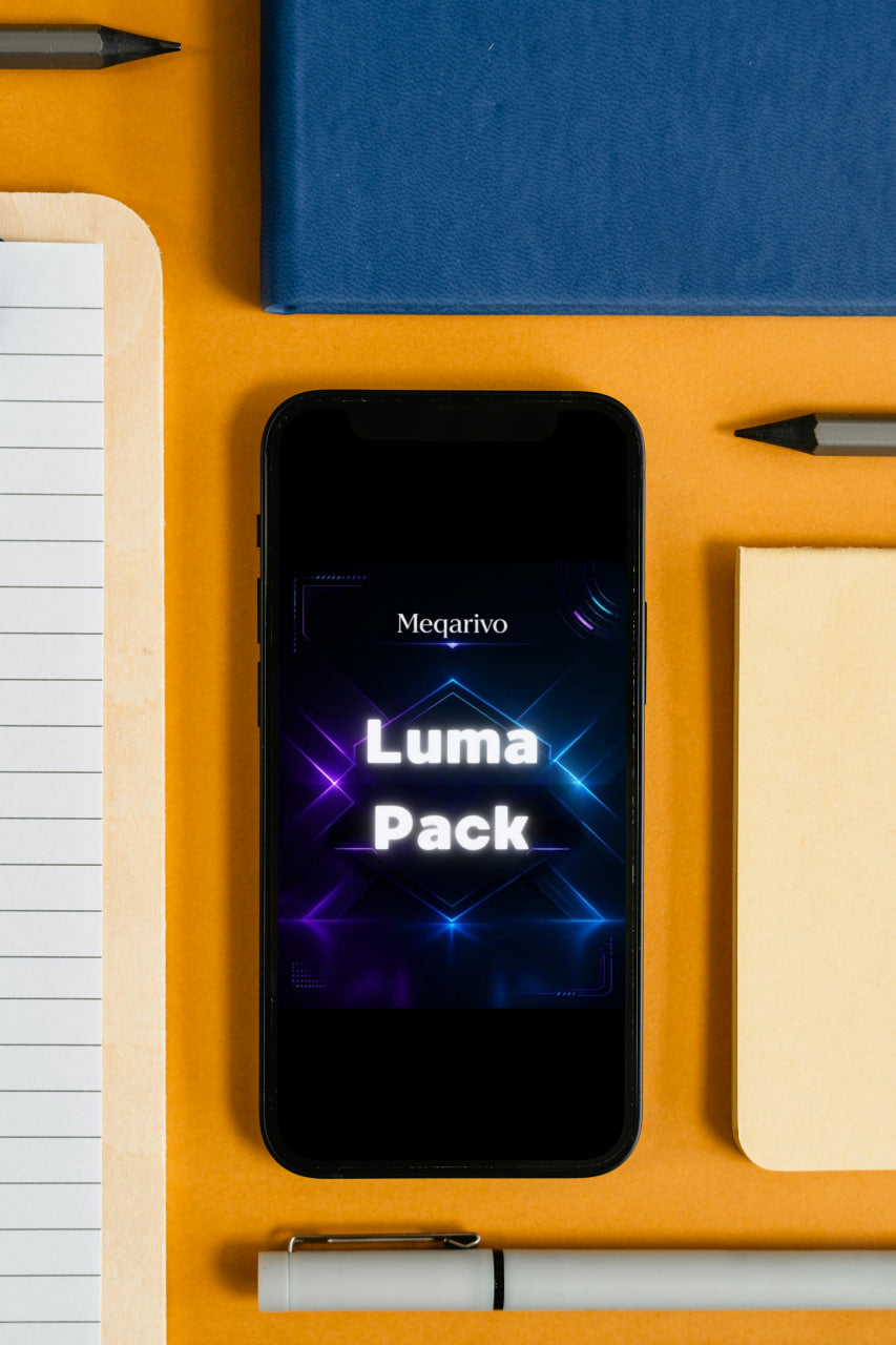 Smartphone displaying 'Luma Pack' on a desk with stationery items